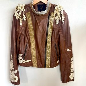 Leather jacket with decorative trimming and zipper pockets.